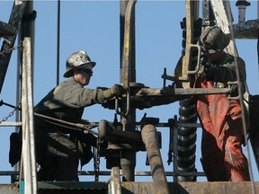 Crew work on a conventional drilling rig at an Encana well near Standard, Alberta Tuesday, October 5, 2010.