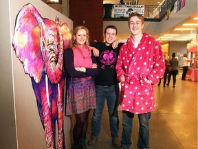 Natalie Badenduck, a founding member of Mount Royal University's Who's Frank? campaign, joins Centennial High School students Ryan Kornblum, centre, and Brett Juvonen alongside the Frank poster before a Pink Shirt Day assembly at Centennial Tuesday February 22, 2015. Frank the elephant is a metaphor for bullying being the "elephant in the room" in classrooms, sports arenas, playgrounds and workplaces.