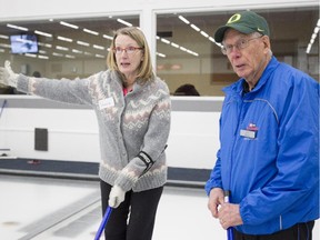 Instructor Bob McClay works with Vanessa Davidson during an Adult Learn to Curl session at the Calgary Curling Club on February 8, 2015.