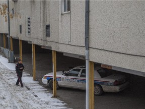 An officer walks to her vehicle at the crime scene of a suspicious death in the 1500 block of 28th Avenue in Calgary, on February 9, 2015.