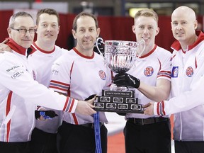 Calgary's Kevin Koe rink celebrates the Boston Pizza Cup Alberta men's curling championship on Sunday in Wainwright. From left, coach John Dunn, lead Ben Hebert, second Brent Laing, third Marc Kennedy and skip Kevin Koe.