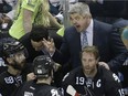 San Jose Sharks head coach Todd McLellan, tops, chats with some of his players during the third period of a playoff game last year.