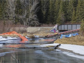 A train car remains in the water by the rail bridge over 40 Mile Creek on the edge of Banff's town boundary on February 24, 2015, two months after the 15-car derailment spilled grain and fly ash into the creek, which feeds into the Bow River about 200 meters downstream.