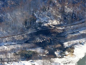 In this aerial photo made available by the Office of the Governor of West Virginia shows a derailed train in Mount Carbon, WV., Tuesday Feb. 17, 2015. The train carrying crude oil derailed Monday night, causing a large fire that forced hundreds of people to evacuate their homes and temporarily shutting down water treatment facilities.