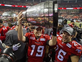 Calgary Stampeders quarterback Bo Levi Mitchell, left and Rob Cote, right celebrate winning the CFL's 2014 Grey Cup Championship with teammates at BC Place Stadium in Vancouver, B.C. Sunday November 30, 2014.  The Stampeders beat the Hamilton Tiger-Cats 20-16.