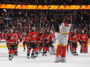 The Calgary Flames salute the crowd after defeating the Vancouver Canucks during an NHL game at Scotiabank Saddledome on February 14, 2015 in Calgary, Alberta, Canada. The Flames defeated the Canucks 3-2.