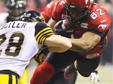 Calgary Stampeders slotback Nik Lewis goes up and through the Hamilton Tiger Cats near the end zone in the 2014 Grey Cup in Vancouver on Nov.30, 2014.