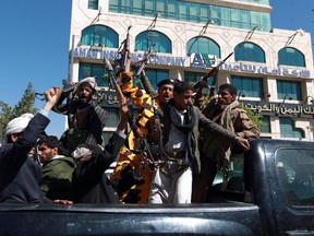 Shiite Huthi fighters shout slogans as they drive in a the back of a vehicle in the Yemeni capital Sanaa on February 11, 2015. Western governments evacuated their diplomats from Yemen on Wednesday as conflict deepened in the impoverished Saudi neighbour which has long been on the front line of the war against Al-Qaeda.