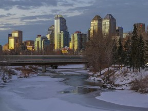 A sunset view of the Calgary downtown skyline, as the c-train crosses a bridge over the Elbow River, in Calgary, on January 7, 2015.