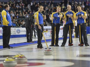 Team Alberta, from left,  coach John Dunn, second Brent Laing, third Marc Kennedy, skip Kevin Koe and lead Ben Hebert, discuss the next best move during a match up against Team Manitoba at the Brier.