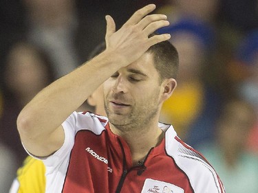 Team Canada third John Morris slaps his hand to his forehead in disappointment during a match up against Team Northern Ontario at the Brier in Calgary, on March 5, 2015.