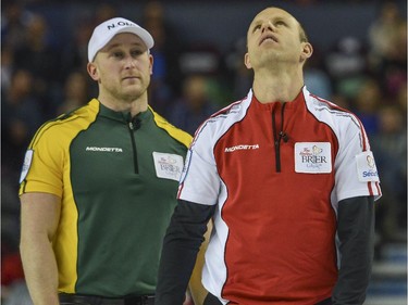 Team Canada skip Pat Simmons, right, reacts to missing his last rock of the match up against Team Northern Ontario, which they ended up losing 6-3 at the Brier in Calgary, on March 5, 2015.