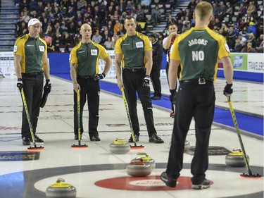Team Northern Ontario, from left, lead Ryan Harnden, third Ryan Fry, second E.J Harnden and skip Brad Jacobs, discuss their next best move during a match up against Team Canada at the Brier in Calgary, on March 5, 2015.