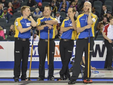 Team Alberta, from left,  third Marc Kennedy, lead Ben Hebert, second Brent Laing and skip Kevin Koe, take a moment break during a match up against Team Manitoba at the Brier in Calgary, on March 5, 2015.