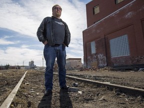 Yale Gelfant, of Yale Custom Cycles, stands on CP tracks near 11th Street S.E., on March 11, 2015. He is worried about the alignment of a new LRT line through Ramsay.