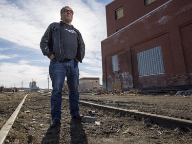 Yale Gelfant, of Yale Custom Cycles, stands on the tracks and the land near 11 Street SE that is causing him and the city issues regarding the placement of a new LRT line in Calgary, on March 11, 2015. He is worried if the line is moved closer to his shop, he may be forced to closed up for good to free space for the LRT line .