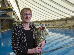 Christine Hampshire, an advocate for the development and expansion of Synchronized Swimming, smiles by the pool she's spent so much of her time at, after being awarded the 2015 Sportsman of the Year Award at the Talisman Centre in Calgary on Thursday.