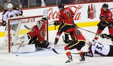 Calgary Flames goalie Karri Ramo reaches out to stop a shot on net by Colorado Avalanche left winger Cody Mcleod at the Scotiabank Saddledome in Calgary on Monday, March 23, 2015. The Calgary Flames lead the Colorado Avalanche, 2-1, at the end of the second period in regular season NHL play.