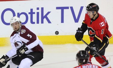 Calgary Flames centre Mikael Backlund, right, chases the puck towards the Colorado Avalanche net after a long airborne shot at the Scotiabank Saddledome in Calgary on Monday, March 23, 2015. The Calgary Flames won over the Colorado Avalanche, 3-2, in regular season NHL play.