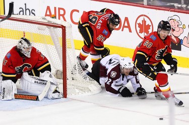 Calgary Flames centre Markus Granlund, right, edges out Colorado Avalanche left winger Gabriel Landeskog in a tight third period at the Scotiabank Saddledome in Calgary on Monday, March 23, 2015. The Calgary Flames won over the Colorado Avalanche, 3-2, in regular season NHL play.