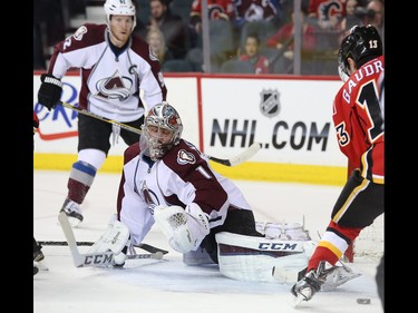 Colorado Avalanche goalie Semyon Varlamov, centre, anticipates a Flames shot on net in Calgary on Monday, March 23, 2015. The Calgary Flames lead the Colorado Avalanche, 2-1, in regular season NHL play.