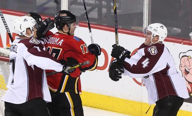 Calgary Flames centre Lance Bouma, centre, engages with Colorado Avalanche defenceman Tyson Barrie at the Scotiabank Saddledome in Calgary on Monday, March 23, 2015. The Calgary Flames lead the Colorado Avalanche, 2-1, at the end of the second period in regular season NHL play.