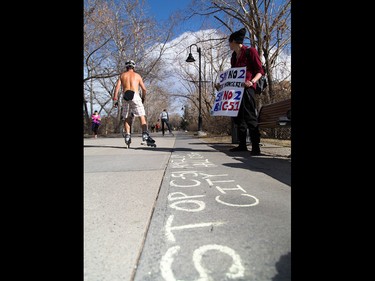 Colin Bullshields holds a sign in the hopes of attracting attention to his protest against the proposed antiterrorism Bill C-51 in Calgary on Friday, March 27, 2015.