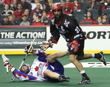 Calgary Roughneck Andrew Mcbride, right, blows over his competition at the Scotiabank Saddledome in Calgary on Saturday, March 28, 2015. The Calgary Roughnecks lost to Toronto Rock, 10-12, in regular season National Lacrosse League play.