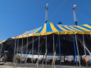 Workers walk the perimeter of the Big Top Cirque du Soleil tent for the show Kurios at Stampede Park in Calgary on Tuesday, March 31, 2015. The big top was raised to a height of nearly six stories.