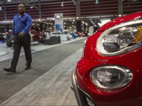 A man browses the FIAT section the 2015 International Auto and Truck Show at the BMO Centre in Calgary, on March 10, 2015.