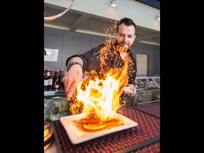 Bartender Jake Hewitt spices up his cocktails at Candela Lounge.