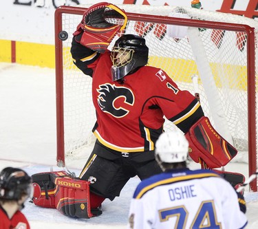 The St. Louis Blues score onCalgary Flames goalie Jonas Hiller during their game at the Scotiabank Saddledome.