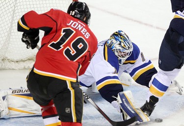 Flames David Jones tries to score on St. Louis Blues goalie Brian Elliott during their game at the Scotiabank Saddledome.