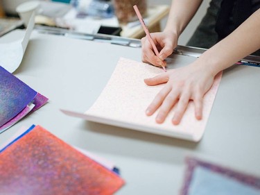 Arkatyiis Miller working on her drawings.