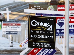 Gavin Young, Calgary Herald 
Real estate signs line Arbour Lake Road outside of the Arbour Lake Landing townhouse development.