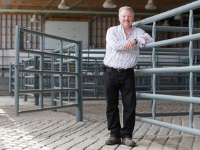 Rich Vesta, CEO of Harmony Beef, poses near the holding pens in Balzac, Alta. on Wednesday, July 30, 2014.