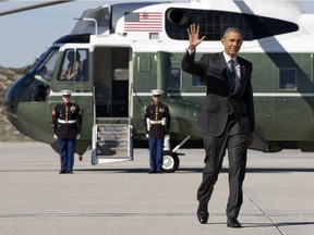 President Barack Obama waves as walks to board Air Force One on departure from Los Angeles International Airport, Friday, March 13, 2015, en route to Phoenix.