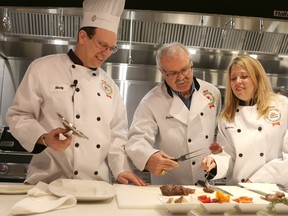 Marty Carpenter, director Canadian Beef Centre of Excellence, left, shows Federal Agriculture Minister Gerry Ritz, middle, and Calgary MP Michelle Rempel, right, the cooking facilities at the Canadian Beef Centre of Excellence in Calgary on March 9, 2015.