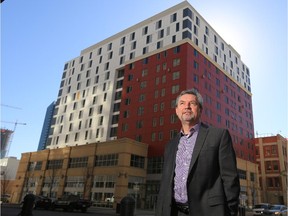 Mustard Seed CEO Stephen Wile stands in front of the organization's new 1010 Centre low income apartment building.