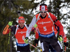 Canada's Nathan Smith (R) competes in the men's 12,5 km pursuit event of the IBU Biathlon Word Cup in the Siberian city of Khanty-Mansiysk, on March 21, 2015. Smith took the first place ahead of Germany's Benedikt Doll and Russia's Anton Shipulin.