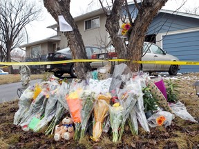 Flowers are piled in front of the Brentwood home where five young people were stabbed to death in this photo taken on Good Friday, April 18, 2014.