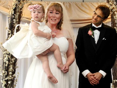 Rachelle Murphy, nee Kennedy, holds their daughter Katherine moments after she and husband Terry were married at the Bridgeland Community Centre Saturday afternoon March 14, 2015. Terry was diagnosed with terminal liver cancer 21 months ago when Rachelle was pregnant and the couple have been beating the odds since.