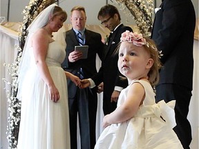 Katherine Murphy looks up as her parents Terry Murphy and Rachelle Kennedy are married Saturday afternoon March 14, 2015 at the Bridgeland Community Centre.
