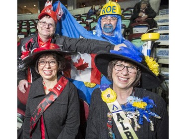 Debbie and Dale Roadhouse, in blue and yellow, and Gail and Kelly Barnes, in red and black, split there cheering between Team Canada and Team Alberta at the 2015 Tim Hortons Brier at the Saddledome in Calgary, on March 2, 2015.