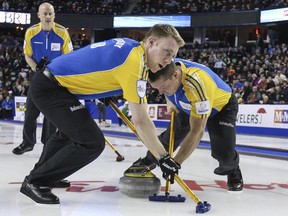 Team Alberta's third Marc Kennedy, front, lead Ben Hebert and skip Kevin Koe are done if they lose another game at the Brier. A split of games on Wednesday has them sitting in the middle of the pack with a 4-4 record.