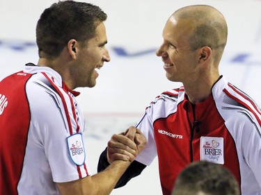 Team Canada's John Morris and skip Pat Simmons celebrate defeating Newfoundland and Labrador 8-6 in the 2015 Tim Horton's Brier semi-final game at the Scotiabank Saddledome on Saturday evening March 7, 2015.