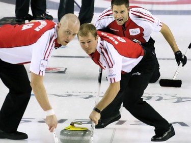 Team Canada's John Morris shouts to sweepers Nolan Thiessen and Carter Rycroft during the 2015 Tim Horton's Brier semi-final game at the Scotiabank Saddledome on Saturday evening March 7, 2015. Team Canada won 8-6