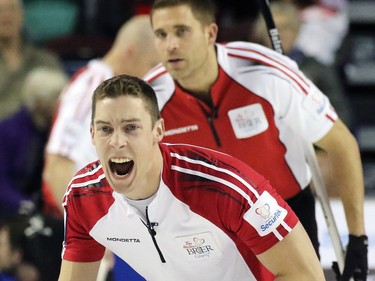 Newfoundland and Labrador's second Brett Gallant yells out while Team Canada's John Morris looks on during the 2015 Tim Horton's Brier semi-final game at the Scotiabank Saddledome on Saturday evening March 7, 2015.