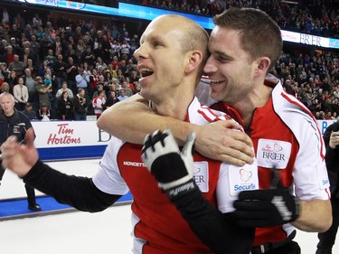Team Canada's skip Pat Simmons and third John Morris celebrate winning the gold medal final of the 2015 Tim Hortons Brier on Sunday March 8, 2015. Team Canada downed Brad Jacobs' Northern Ontario team 6-5 in an extra end.