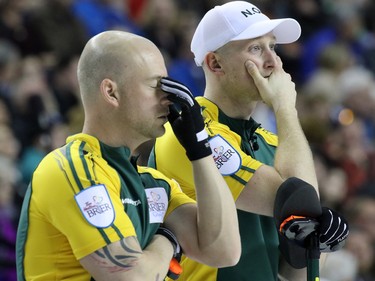 Northern Ontario's third Ryan Fry, left and second E.J. Harnden show their dismay as they see their chances slipping away in the gold medal final of  the 2015 Tim Hortons Brier on Sunday March 8, 2015. Team Canada downed Brad Jacobs' Northern Ontario team 6-5 in an extra end.